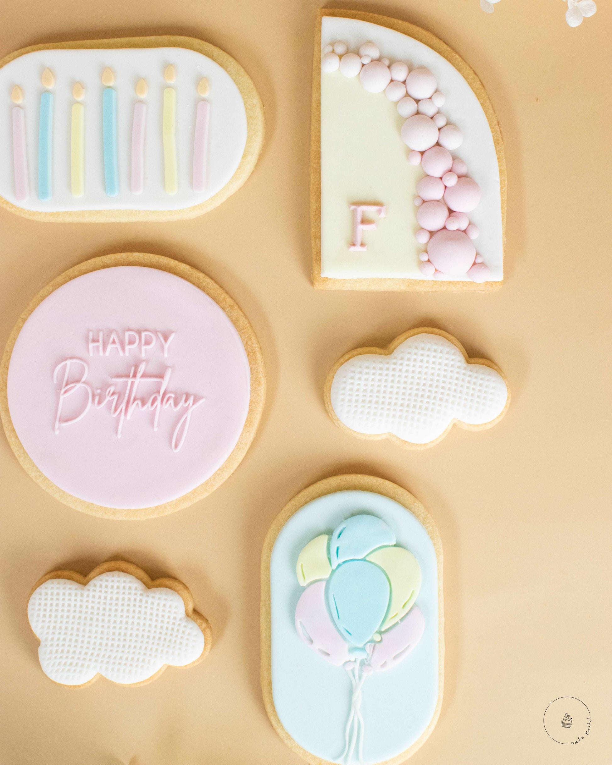 Birthday Cookies. Round cookie with caption Happy Birthday, oval cookie with birthday candles, cloud-shaped cookies, oval cookie with balloons  